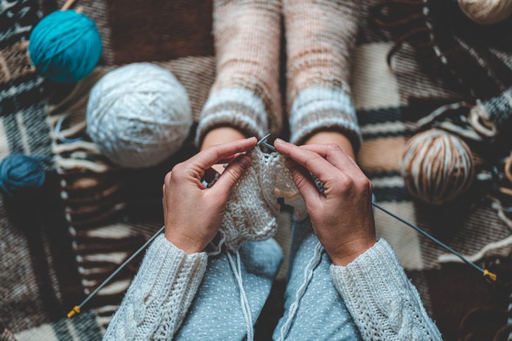 A woman knits yarn that was a comfort buy during the coronavirus crisis