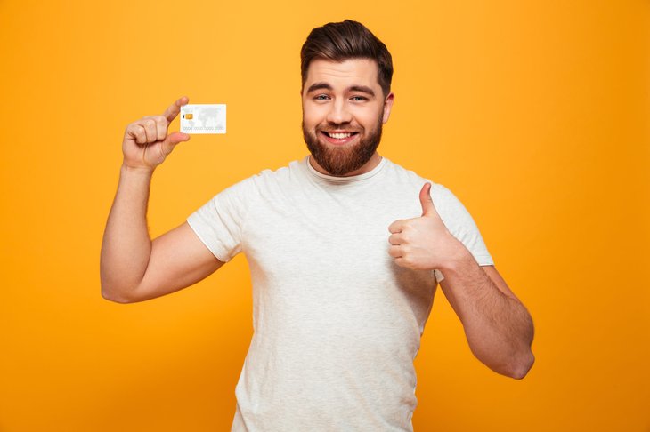 Man giving a thumbs up happy with his credit card rewards
