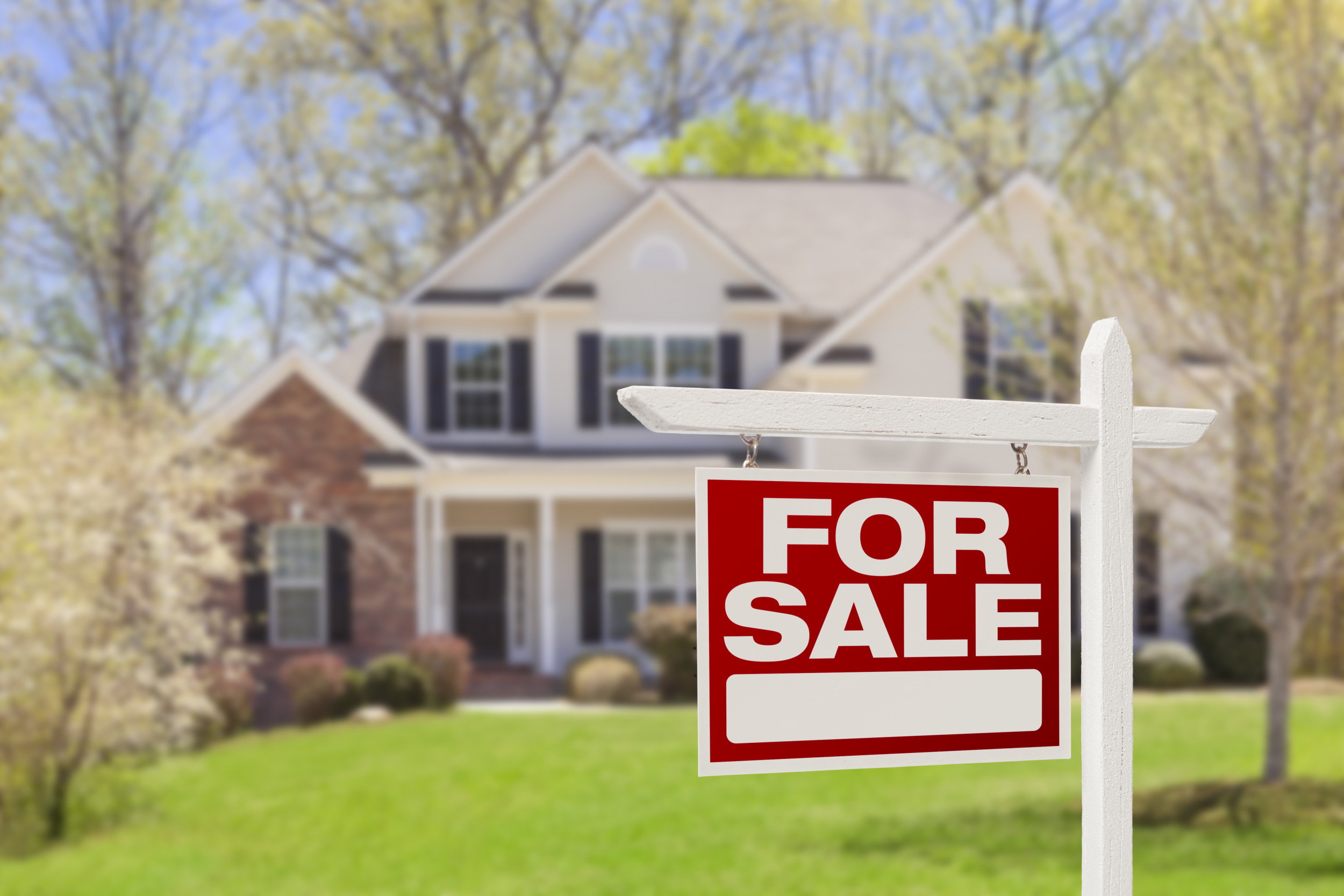 A "for sale" sign outside a home.