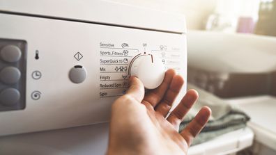 Man preparing the washing machine to start working