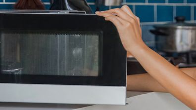 Woman using microwave