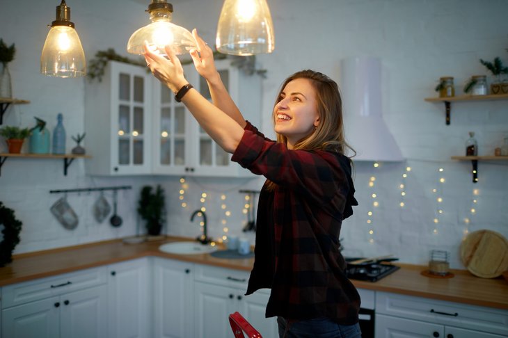 Woman changing a lightbulb