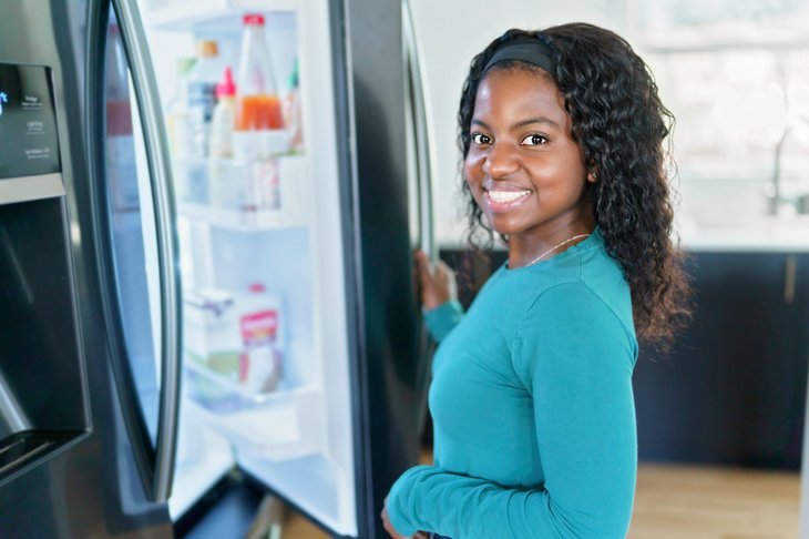 Woman opening a fridgerator