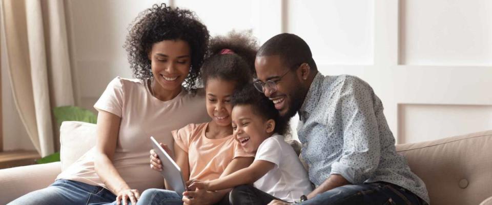 Happy family looking at tablet together